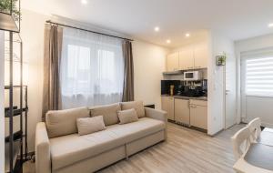 a living room with a couch and a kitchen at Secret Collection Thermenresort in Frauenkirchen