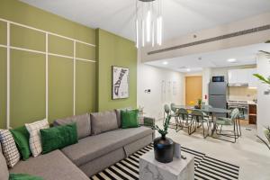 a living room with a couch and a table at Luxury Radiant Boulevard Residence in Mushayrib