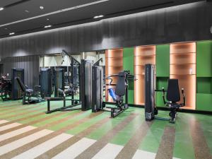 a gym with treadmills and elliptical machines at Luxury Radiant Boulevard Residence in Mushayrib