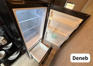 an overhead view of an empty refrigerator with the door open at Room 2type Fuji Trip House Sepia 3F and Deneb 4F in Azagawa