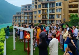 a crowd of people standing around a ceremony in front of a building at Luxury Aloha Apartments, Rishikesh in Rishīkesh