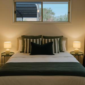 a bedroom with a large bed with two lamps at Sunnybank Hills Haven - Family Comfort Retreat in Brisbane