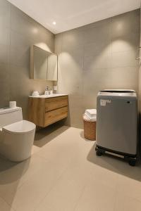 a bathroom with a toilet and a sink at Rose & Golf at Rose Apple Square in Siem Reap