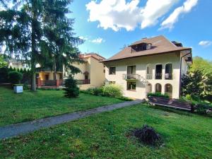 a large house with a yard with a grass field at Willa Anna in Nałęczów +7 photos