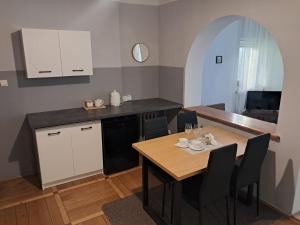 a kitchen and dining room with a wooden table at Willa Anna in Nałęczów