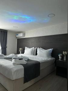 a bedroom with a large bed with white pillows at Hotel Sevinch in Tashkent