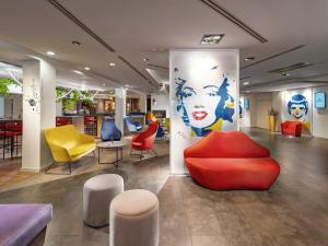 a lobby with colorful chairs and tables in a store at Clarion Congress Hotel Bratislava in Bratislava