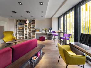 a living room with a couch and chairs and a table at Clarion Congress Hotel Bratislava in Bratislava
