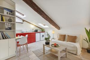 a living room with a couch and a table at Studio Place Masséna Vieux Nice - situation idéale in Nice