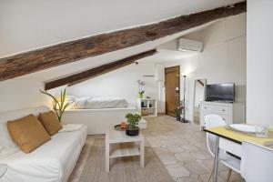a living room with a white couch and a table at Studio Place Masséna Vieux Nice - situation idéale in Nice
