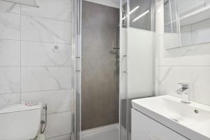 a bathroom with a shower and a toilet and a sink at Studio Place Masséna Vieux Nice - situation idéale in Nice +6 photos