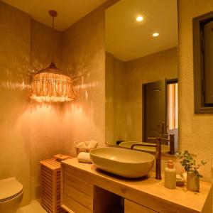 a bathroom with a large bowl sink on a counter at Themis Coddess Cave Suites in Santorini