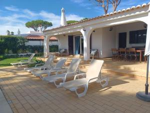 a row of white chairs sitting on a patio at Alsouk in Vilamoura