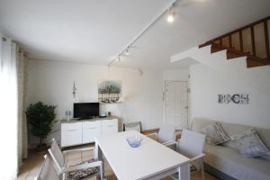 a living room with a white table and chairs at Casas Blancas 37 in Miami Platja