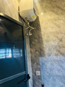 una habitación con una puerta y un ventilador y una pared en T Apartment, en Ogijo