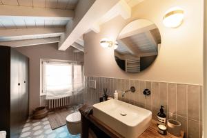 a bathroom with a sink and a mirror at Once in a Lifetime - by MyHomeInComo in Laglio +46 photos