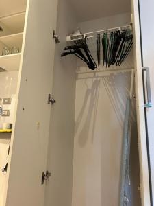 a door with a bunch of umbrellas in it at Auckland CBD Apartment with Sky Tower View in Auckland