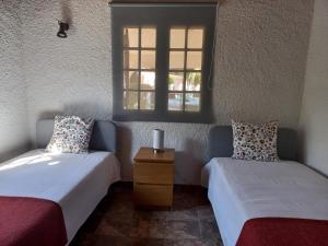 a room with two beds and a window at Alsouk in Vilamoura +26 photos