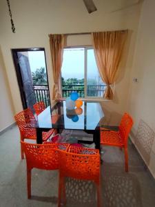 Un comedor con mesa y sillas y una ventana. en MK sea view guest house, en Visakhapatnam