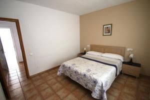 a bedroom with a bed and a mirror at Villa Atenea in Miami Platja +21 photos