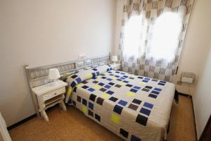 a small bedroom with a bed and a window at Villa rustical 14 in Montroig +17 photos