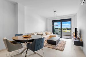 a living room with a table and a couch at Casa La Vida Bella in San Miguel de Salinas