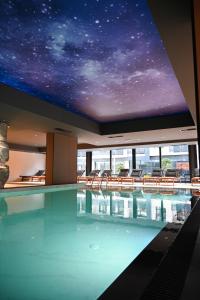 a swimming pool with a starry sky on the ceiling at Apartmani Aurora Zlatibor in Zlatibor