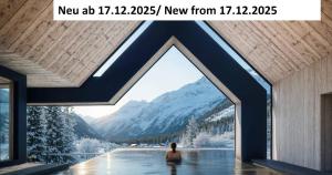 a woman sitting in a pool with a view of a mountain at Forster's Naturresort in Neustift im Stubaital