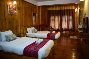 Ένα ή περισσότερα κρεβάτια σε δωμάτιο στο Hotel Elysium