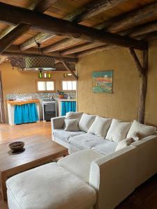 ein Wohnzimmer mit einer weißen Couch und einem Tisch in der Unterkunft Malva Rosa Relax La Juanita in José Ignacio