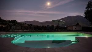 a swimming pool at night with a view of the mountains at Tropical Studio in Órgiva
