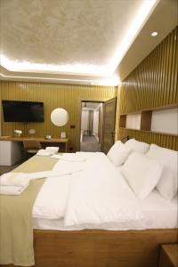 a bedroom with a large bed with white sheets at Aqua Raj ND in Novi Pazar +88 photos