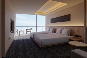 a bedroom with a large white bed and a large window at Hotel Fork & Knife Miyajima in Miyajima