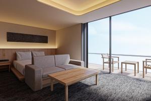 a hotel room with a couch and a table at Hotel Fork & Knife Miyajima in Miyajima