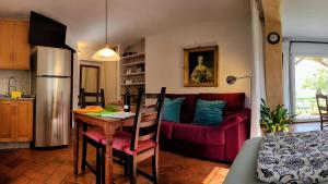 a living room with a table and a red couch at Tropical Studio in Órgiva