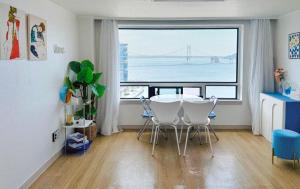 a dining room with a table and a large window at 유니크 in Busan