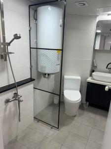 a bathroom with a toilet and a sink at 유니크 in Busan +3 photos