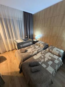 a bedroom with two beds in a room at Villa Gold Poznań in Poznań