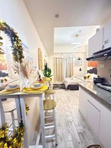 a kitchen and living room with a table and chairs at The Fyangz Luxe Staycation Near Anjo World in Cebu