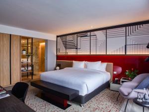 a bedroom with a large bed and a living room at Pullman Lima Miraflores in Lima