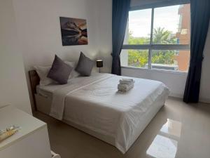 ein Schlafzimmer mit einem großen Bett mit einem großen Fenster in der Unterkunft Chic B309 in Ban Nong Chaeng + 17 Fotos