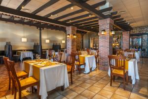 a restaurant with tables and chairs in a room at Occidental Jandía Royal Level - Adults Only in Morro del Jable