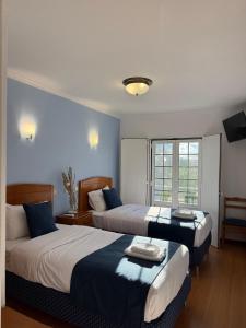 Postel nebo postele na pokoji v ubytování Hospedaria Canto do Rossio