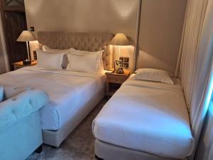 a hotel room with two beds and a couch at The Bellwood Manor in Nuwara Eliya +40 photos