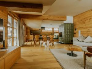 a living room with a couch and a table at Almrausch Lech Apartments in Lech am Arlberg