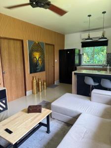 a living room with a couch and a table at Zout Villas in Thong Sala