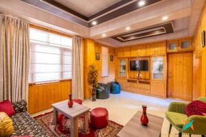 a living room with a couch and a table at Zostel Homes Shoghi, Shimla in Shogi +18 photos