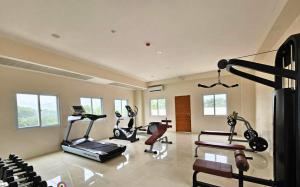 a gym with three exercise bikes in a room at Fyangz Mini Karaoke Condo Staycation in Minglanilla