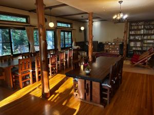 a room with wooden tables and chairs in a library at Lodge Jotenki in Kiso