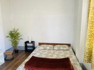 a bedroom with a bed with a rug on it at Maple Homestay in Kohīma